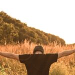 man standing in the middle of field